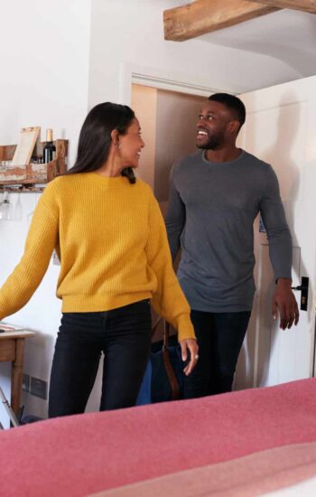 Couple Spending Romantic Weekend Away Opening Door Of Hotel Room